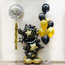 Композиция из гелиевых шаров в черно золотом стиле с фигурой из звёзд